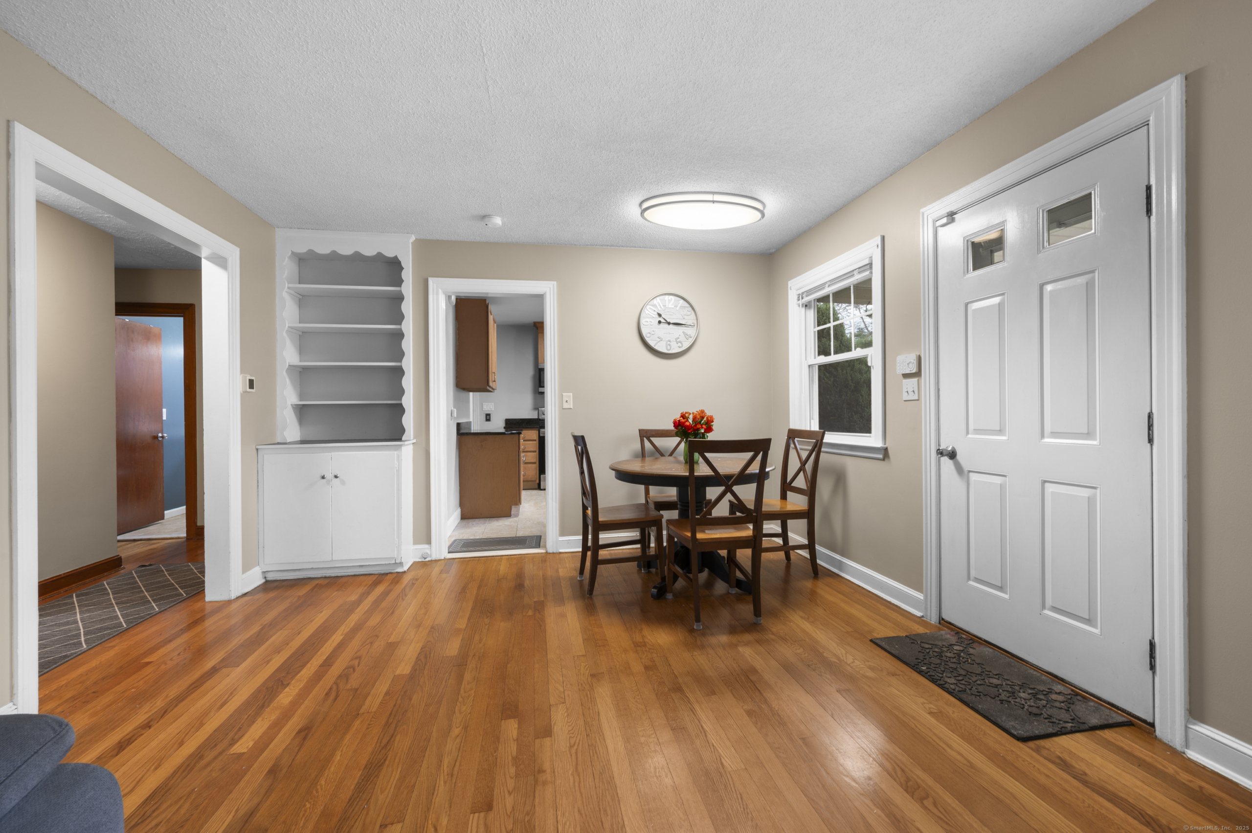 Dining area at 140 Woodhouse Ave featuring a classic white built-in corner hutch and hardwood flooring.