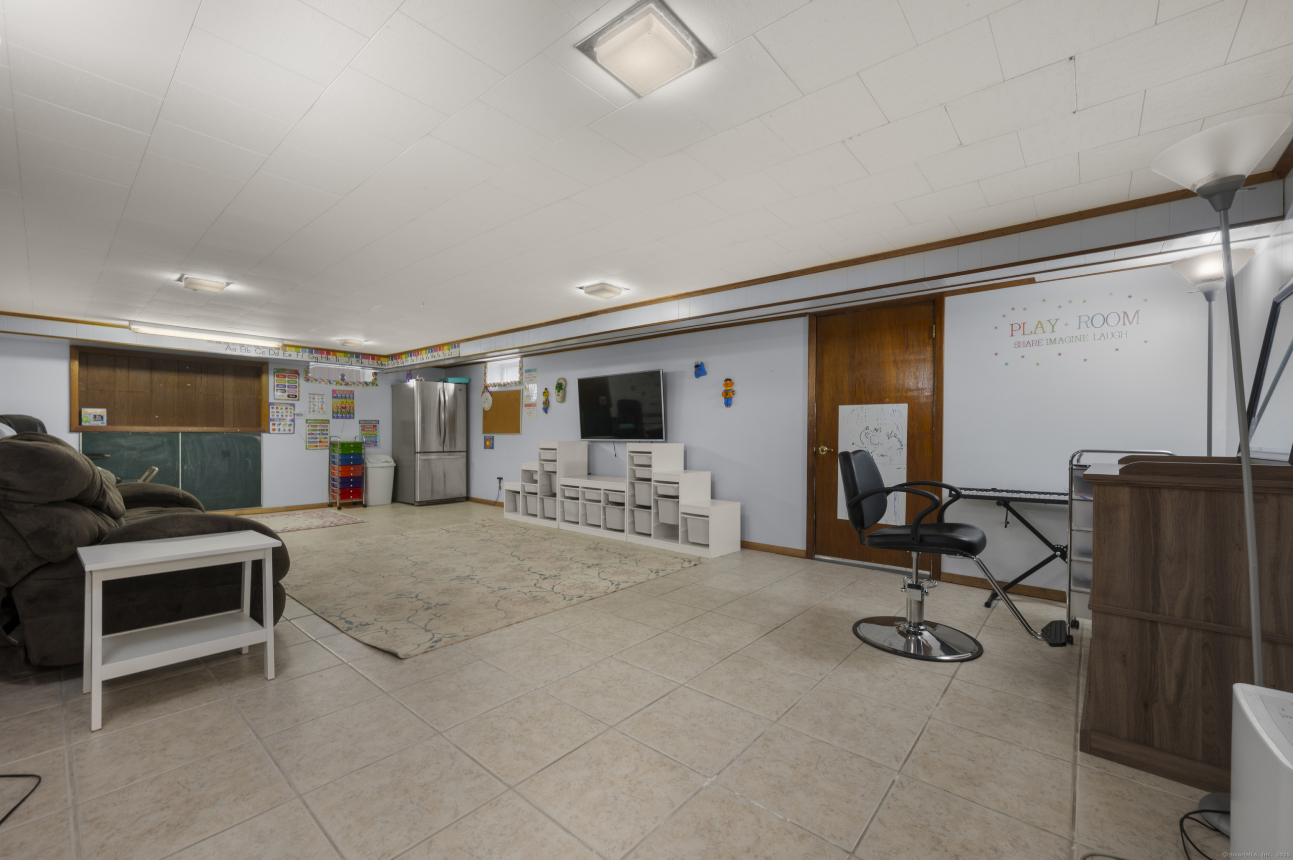 Large finished basement at 140 Woodhouse Ave used as a playroom and recreation center.