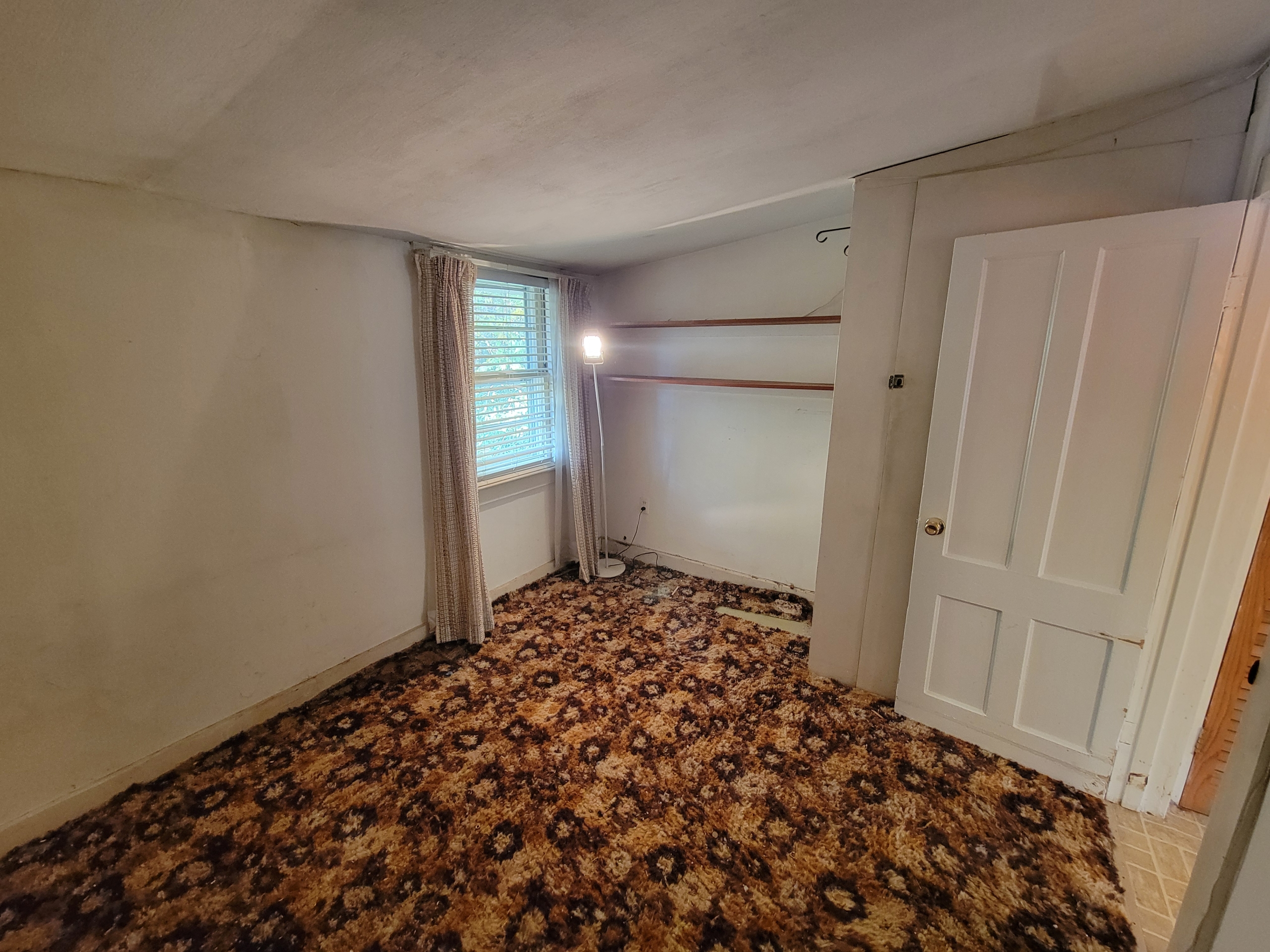 Interior bedroom at 60 Chestnut Lane with patterned carpet and white walls, ready for modern updates.