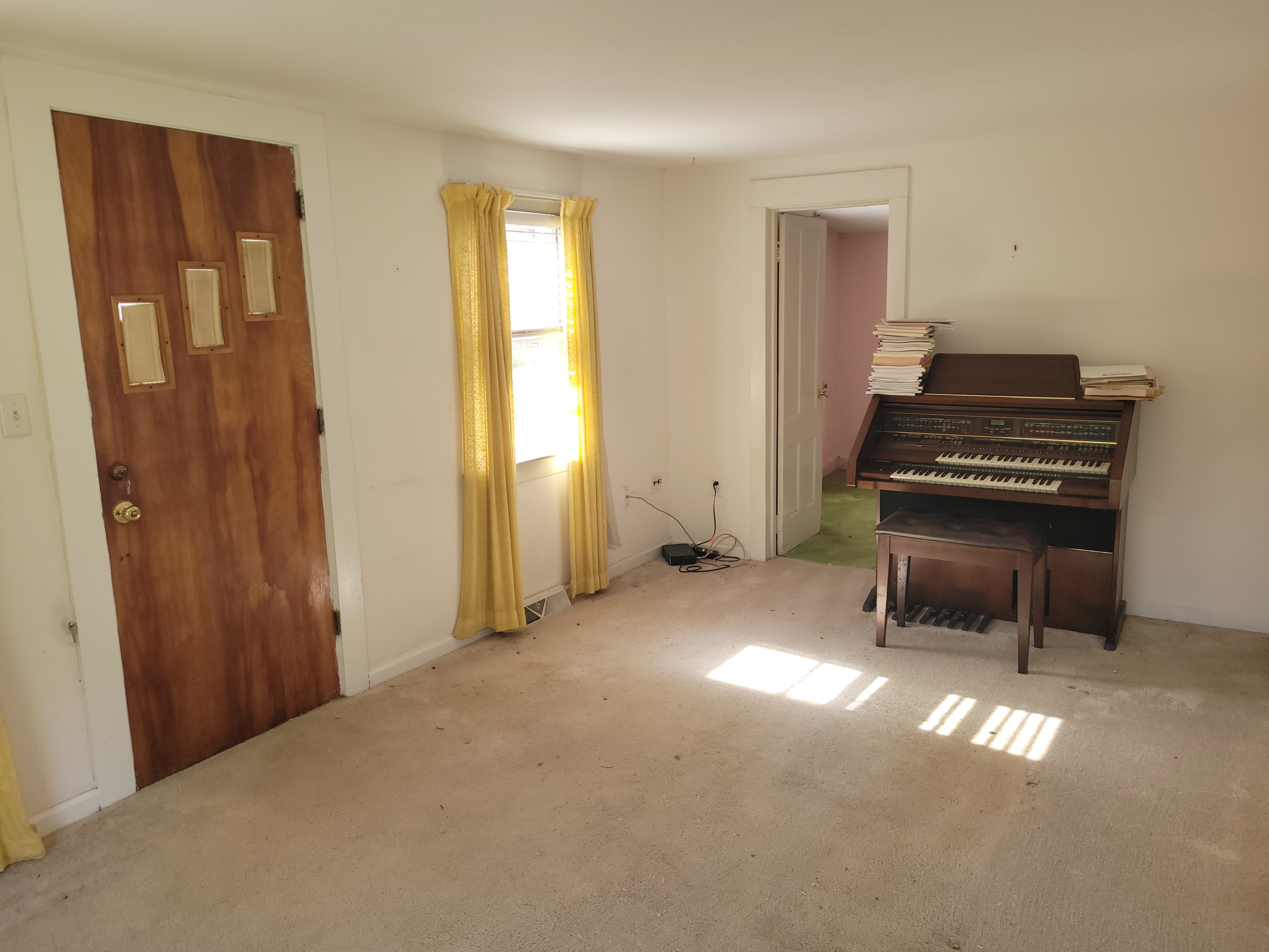 Front entryway of 60 Chestnut Lane with a vintage wood door and sunlit living space.