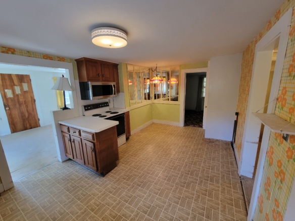 View of the eat-in kitchen area at 60 Chestnut Lane showing the transition to the living spaces.