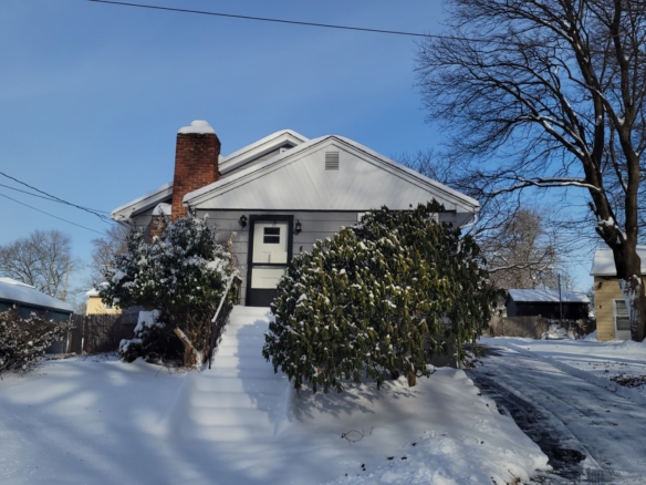 Front view of the entryway at 78 Summit St, Meriden, CT, with snow-covered steps and a white front door.