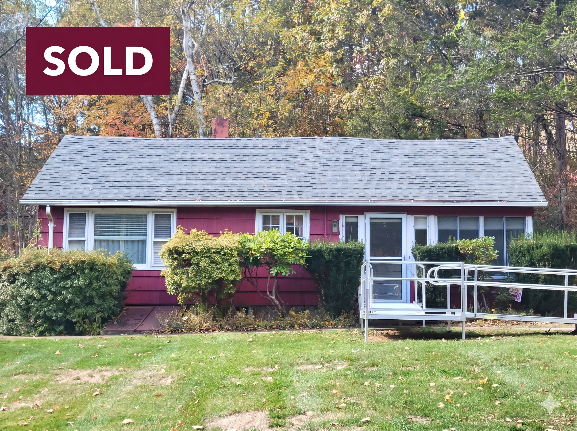 Front exterior of a red ranch-style home at 60 Chestnut Lane, Hamden, CT 06518, featuring a newer roof, level green lawn, and a professional metal accessibility ramp in the desirable Mt. Carmel neighborhood.