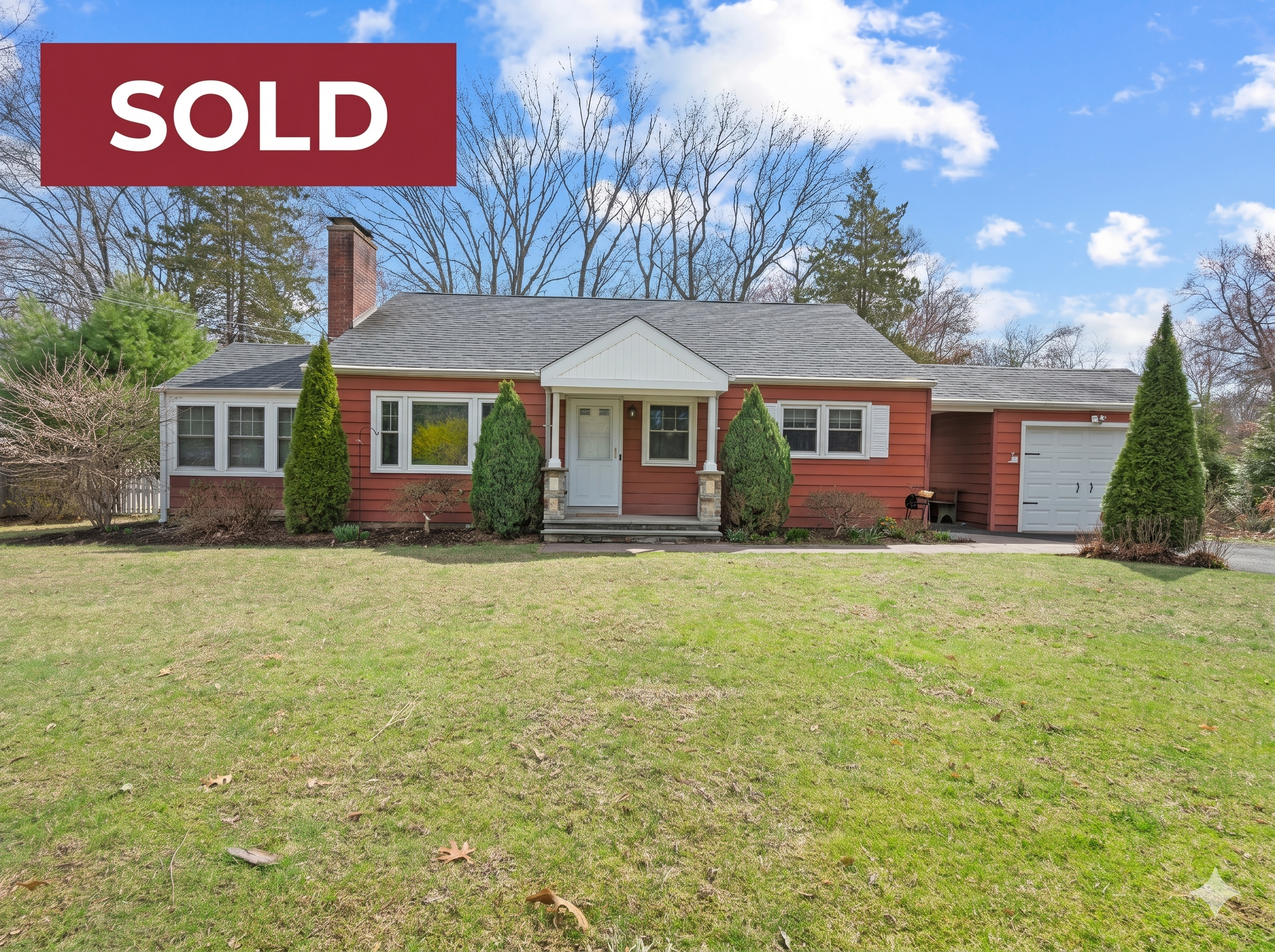 Exterior photograph of 140 Woodhouse Ave, Wallingford, CT 06492, a charming, single-family red-shingled ranch home that is now sold. The image features a large front lawn, a brick chimney, a stone and white-columned portico, and multiple evergreen conifer trees framing the entrance and garage. A red 'SOLD' banner is overlaid in the upper left.