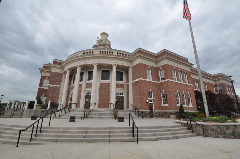 The historic Hamden Memorial Town Hall at 2372 Whitney Avenue, Hamden, CT, featuring Classical Revival architecture, a central clock tower, and white Ionic columns—captured for Hamden real estate expert John Smolenski.