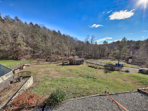 A wide view of the sloping backyard and scenic valley at 1101 Hickory Hill Road in Thomaston, Connecticut.