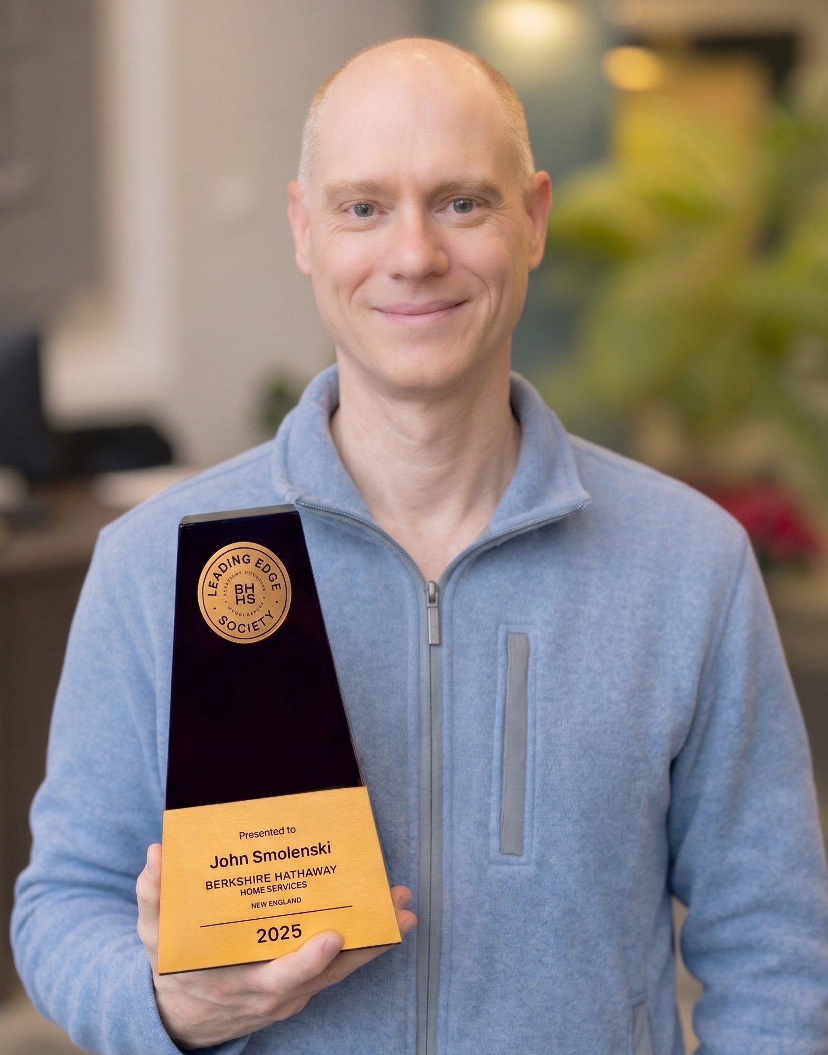 John Smolenski is holding an Leading Edge Society Award.