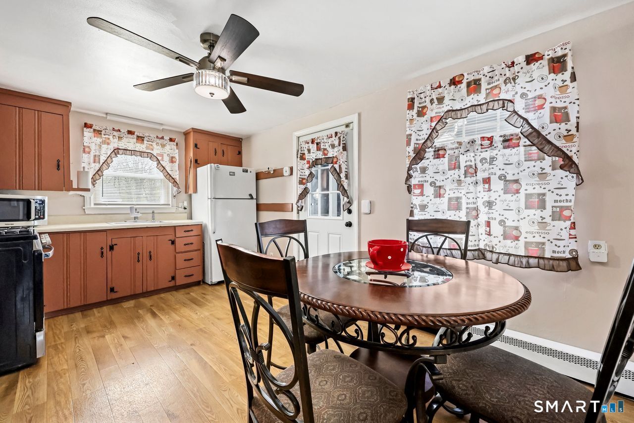 Inviting eat-in kitchen area featuring a round dining table and ceiling fan.