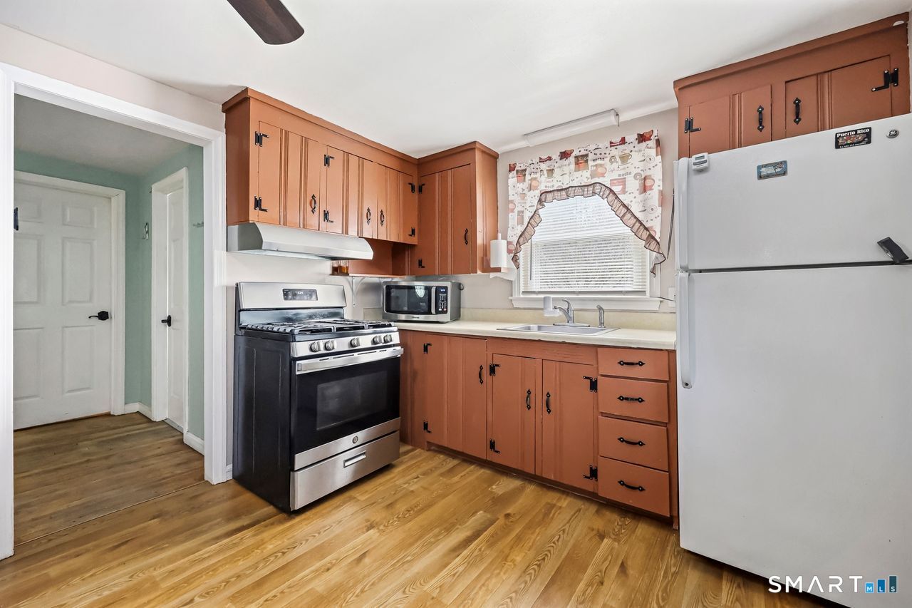 Classic kitchen featuring wooden cabinets and stainless steel appliances.