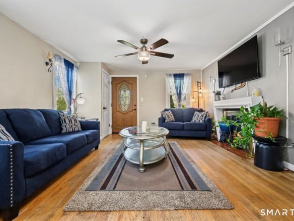 Stylish blue sofas and glass coffee table in a modern living room.