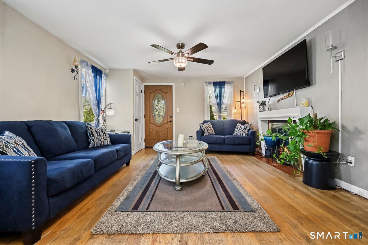 Stylish blue sofas and glass coffee table in a modern living room.