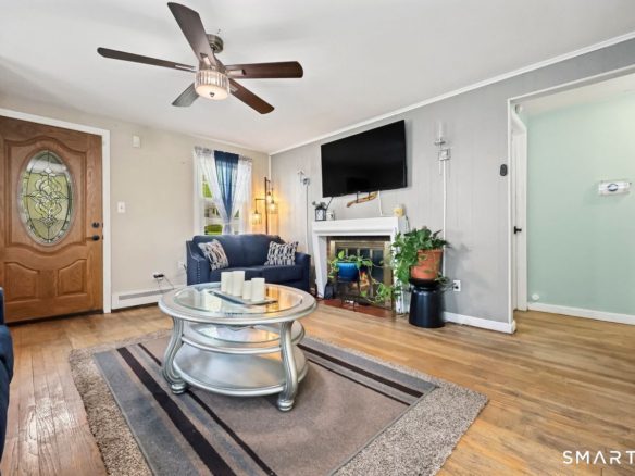 Wide-angle view of a sunlit open-concept living area and entryway.