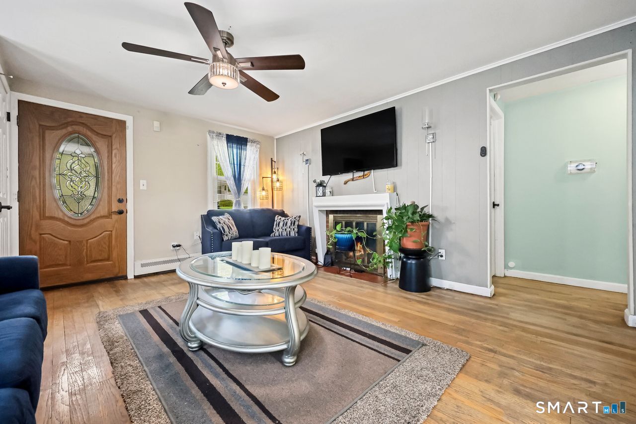 Wide-angle view of a sunlit open-concept living area and entryway.