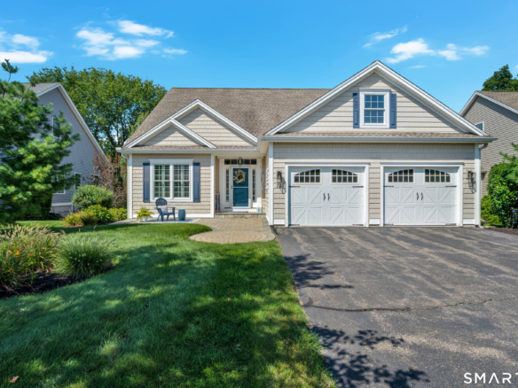 Front exterior of 10 Crestview Drive in Middlefield CT with two-car garage and landscaped yard