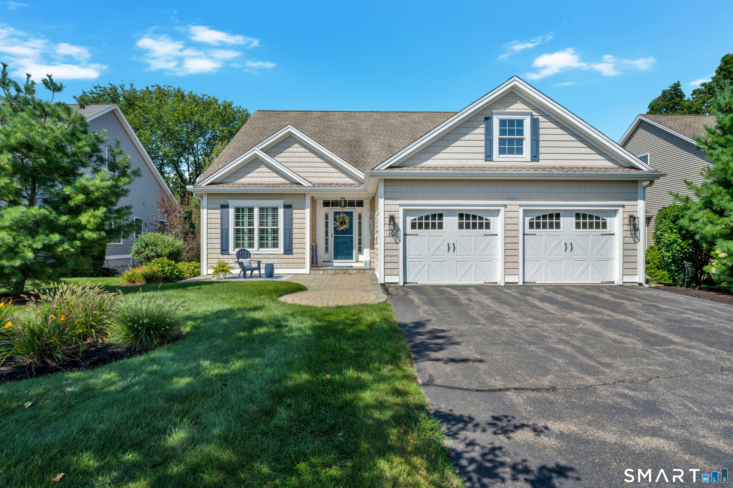 Front exterior of 10 Crestview Drive in Middlefield CT with two-car garage and landscaped yard