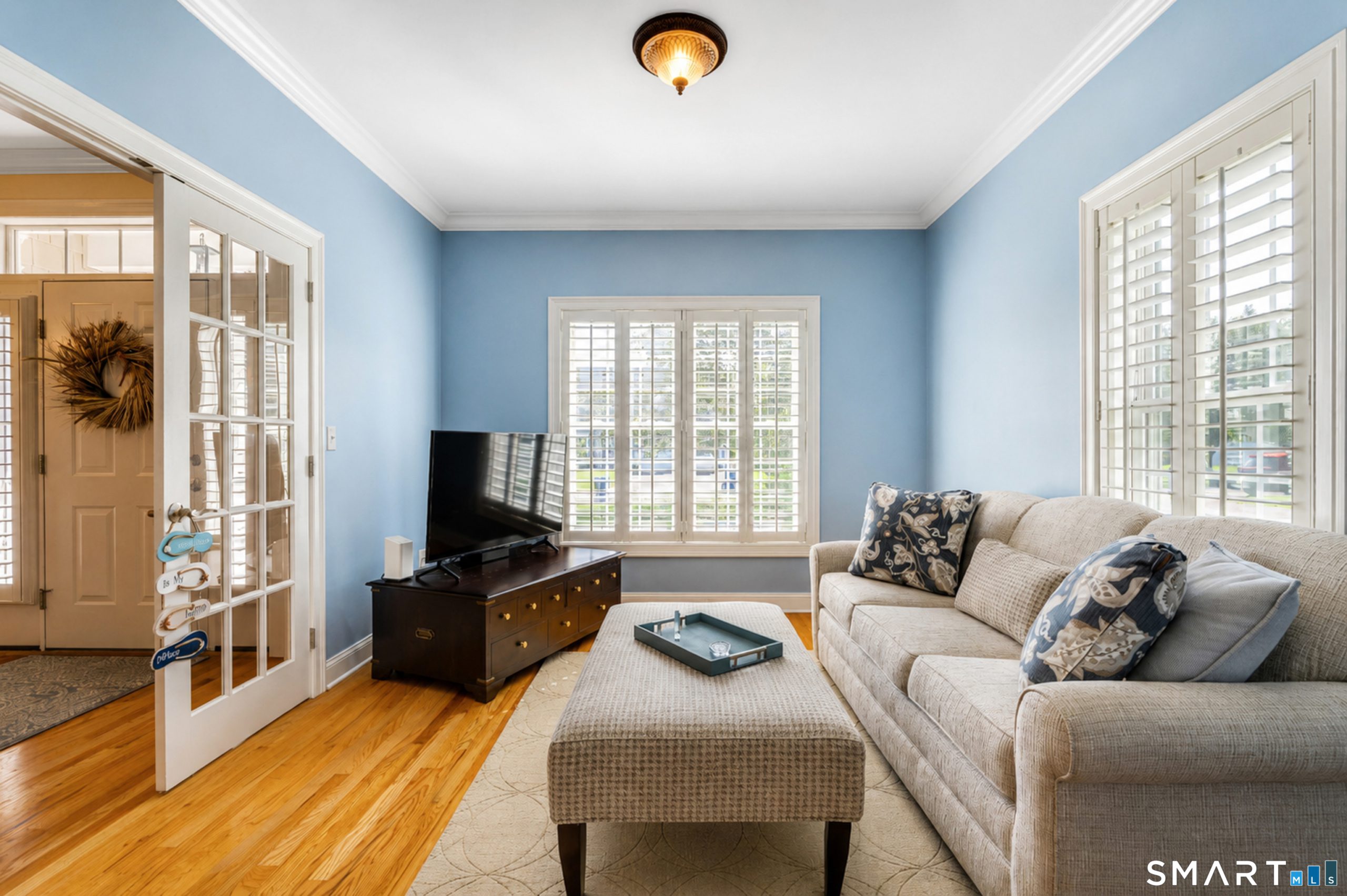 Den at 10 Crestview Drive in Middlefield with hardwood floors, French doors and plantation shutters