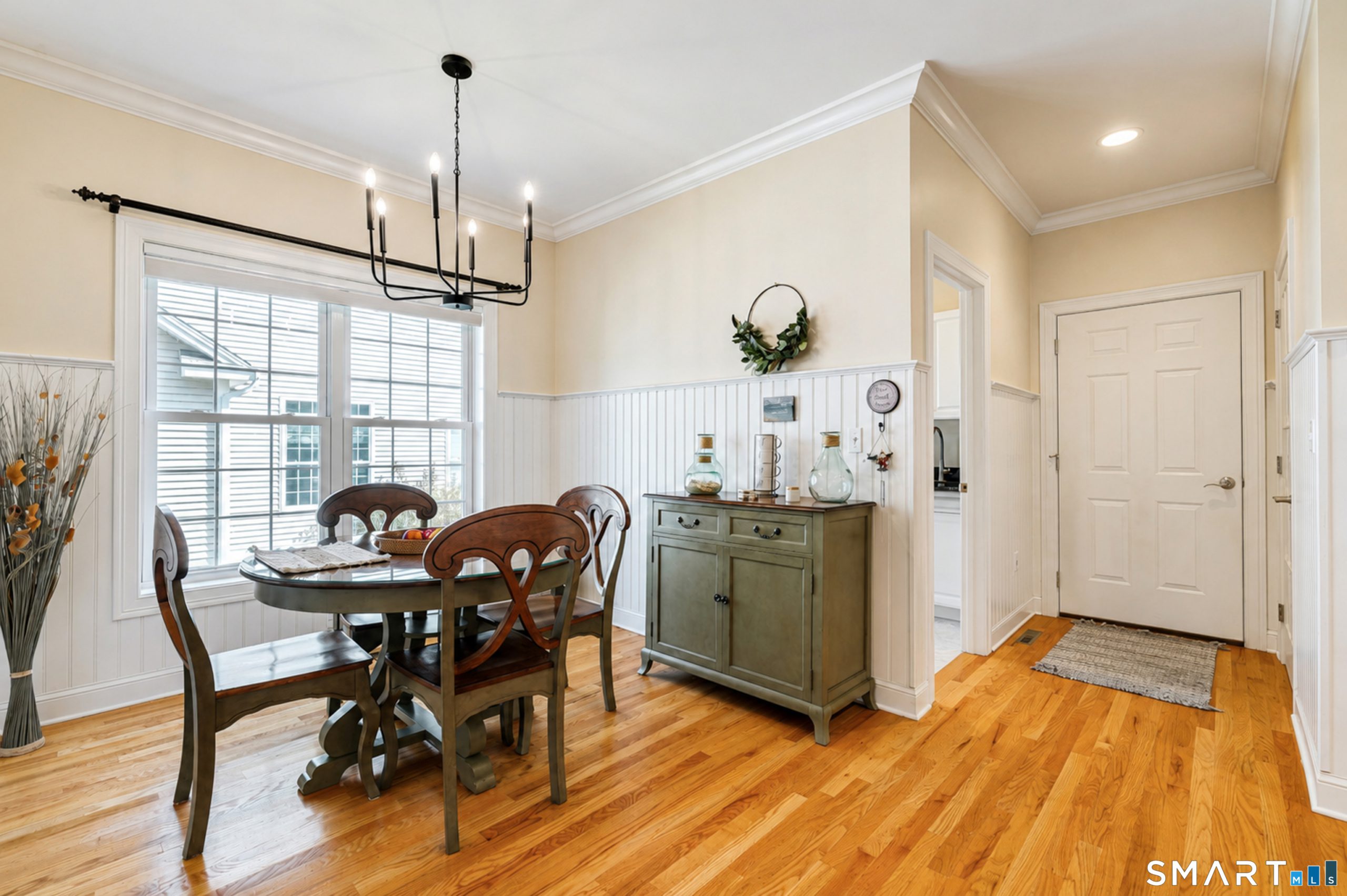 Breakfast nook at 10 Crestview Drive with hardwood floors, large window and beadboard detailing