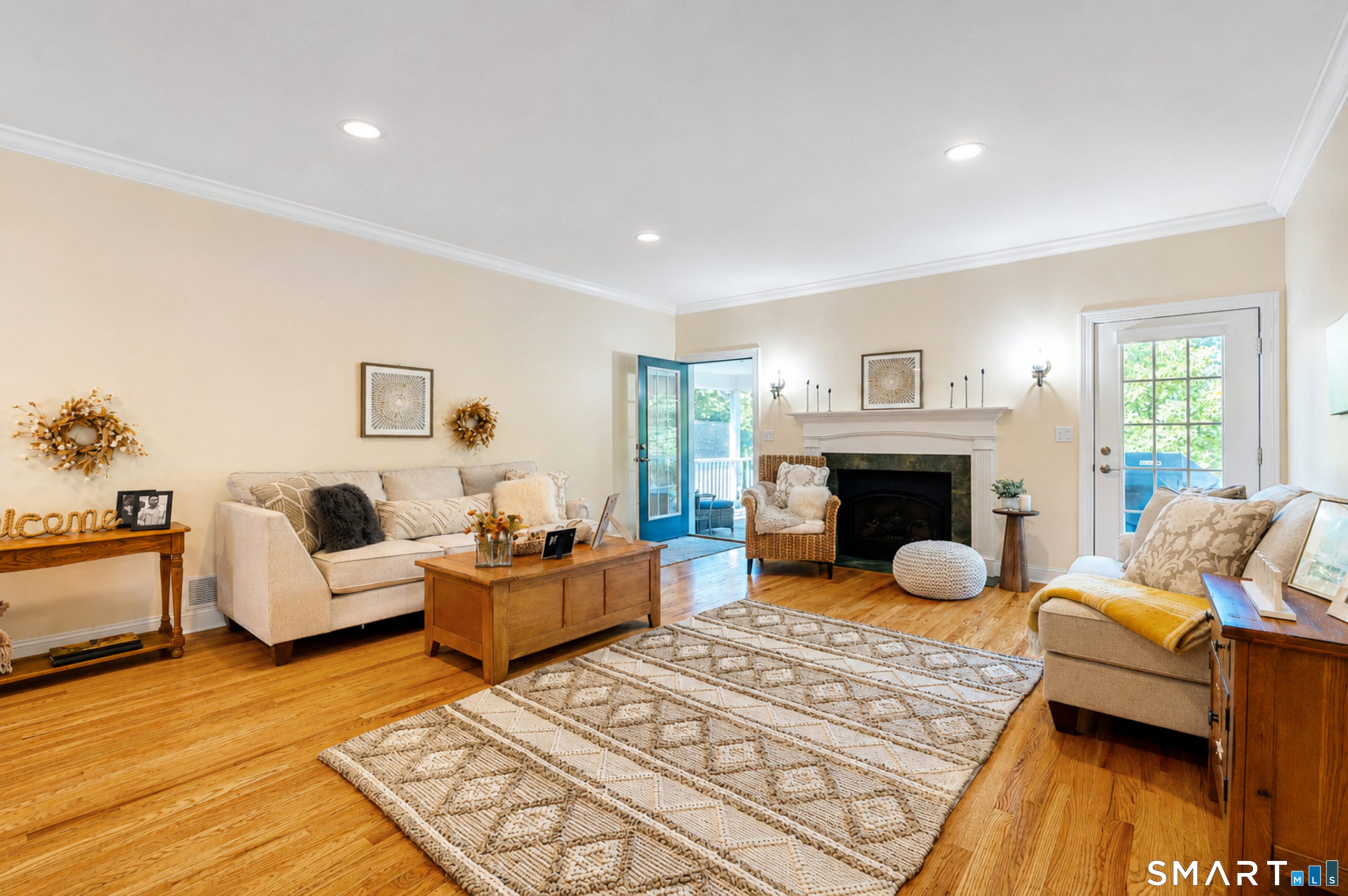 Living room at 10 Crestview Drive with hardwood floors, fireplace and access to screened porch